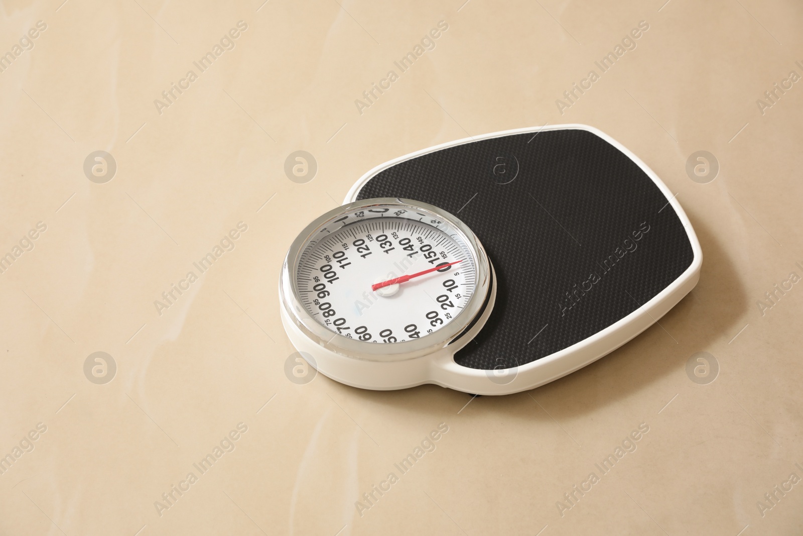 Photo of Scales on tiled floor, space for text. Overweight problem