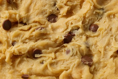 Photo of Texture of raw dough as background, closeup. Cooking chocolate chip cookies