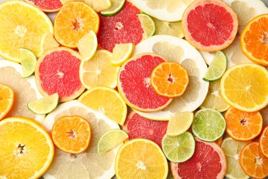 Different citrus fruits as background, top view