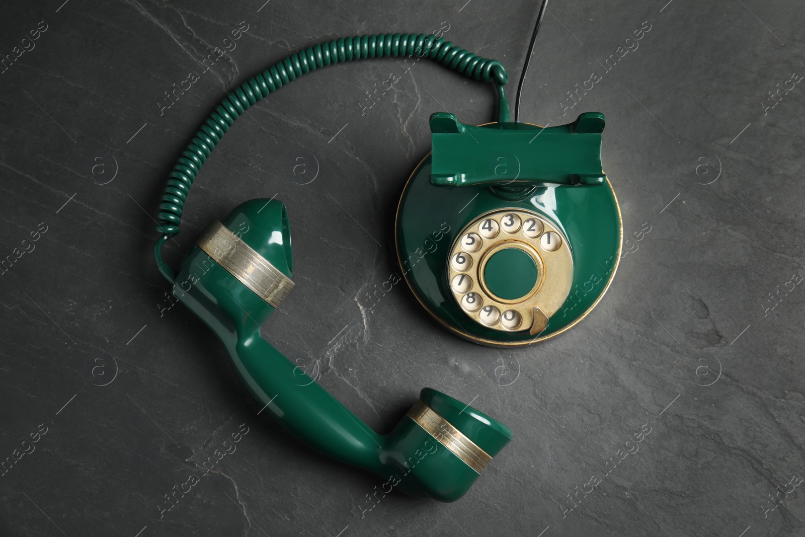 Photo of Vintage corded phone on black stone table, top view