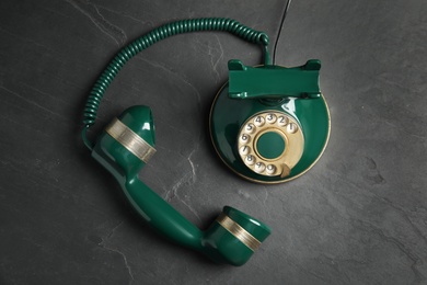 Photo of Vintage corded phone on black stone table, top view