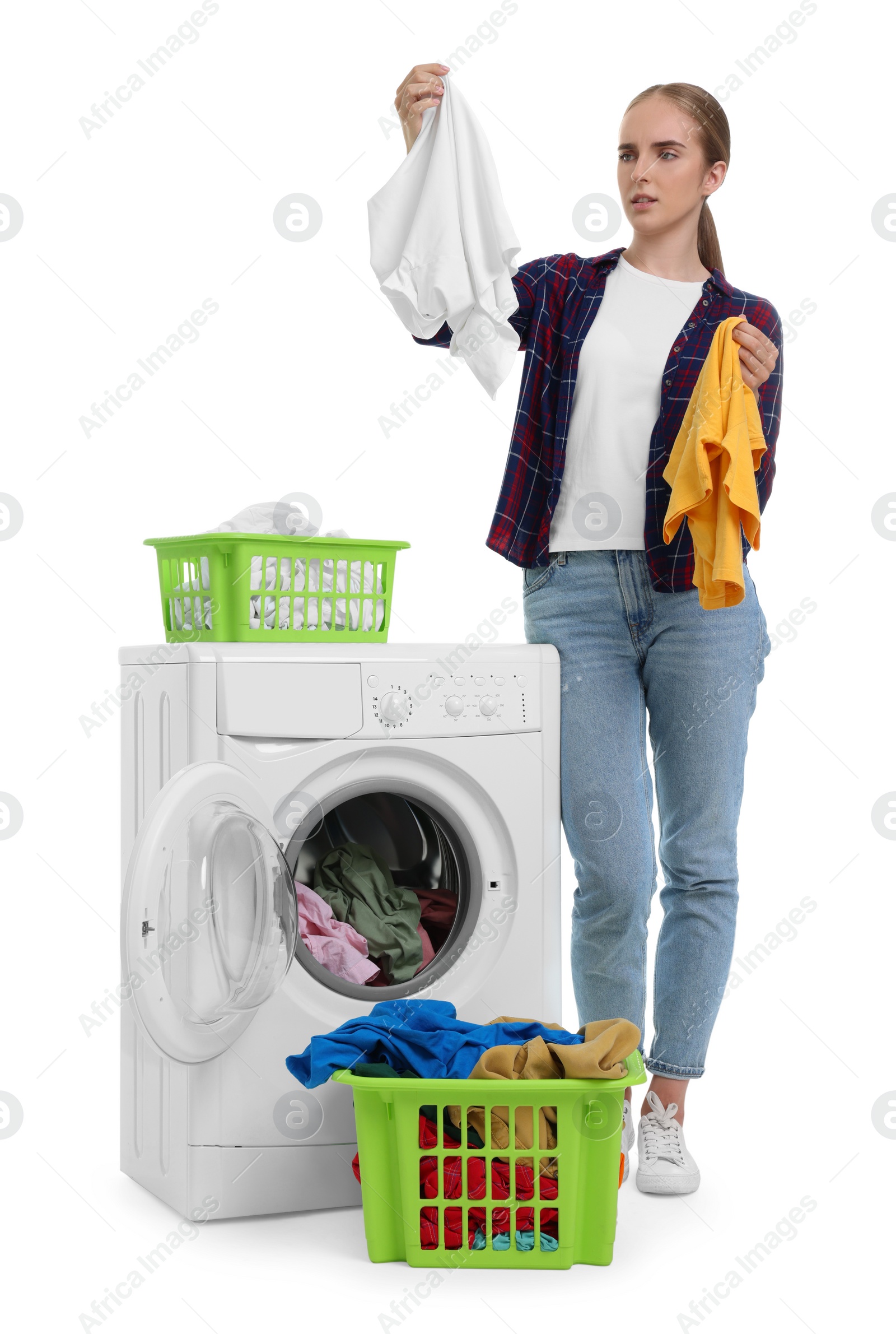 Photo of Beautiful young woman with laundry near washing machine on white background