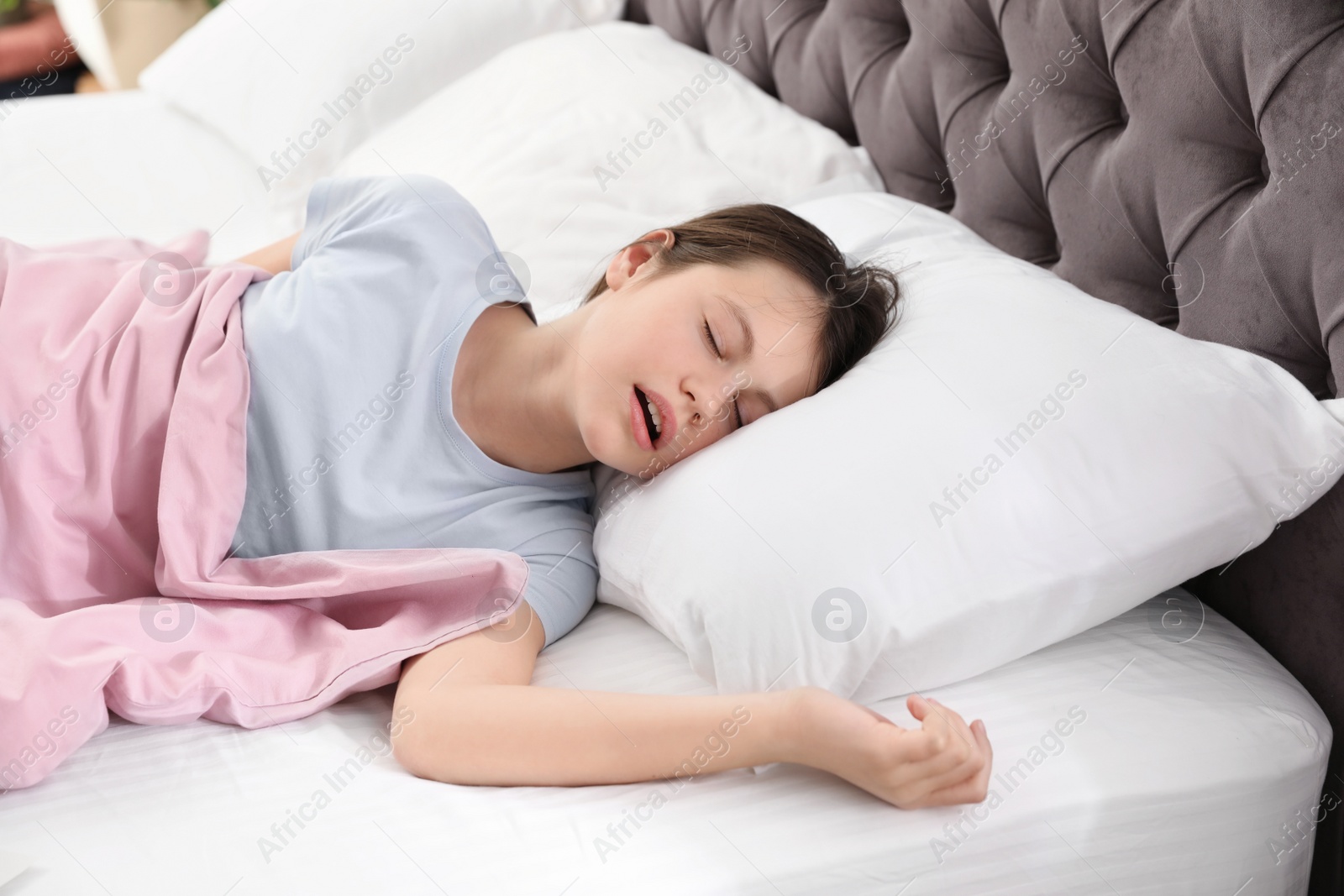 Photo of Beautiful little girl sleeping in bed at home