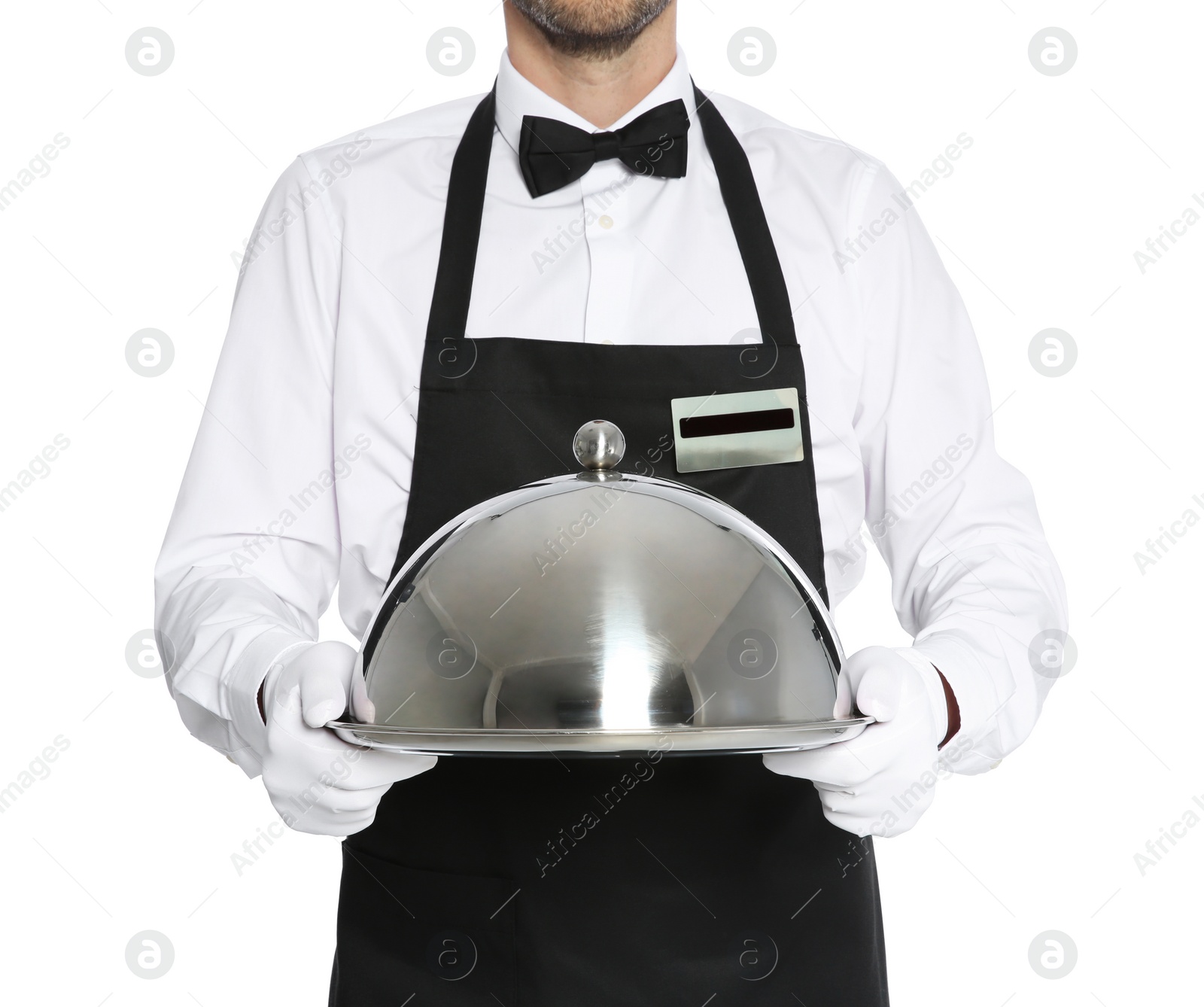 Photo of Young waiter holding metal tray with lid on white background