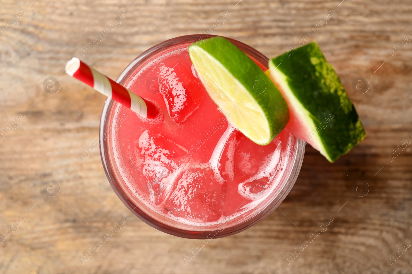 Photo of Delicious fresh watermelon drink on wooden table, top view