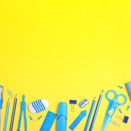 Flat lay composition with different school stationery on yellow background. Space for text