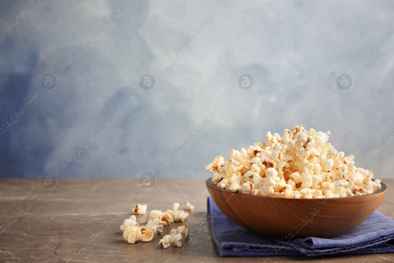 Photo of Bowl of tasty fresh popcorn on table