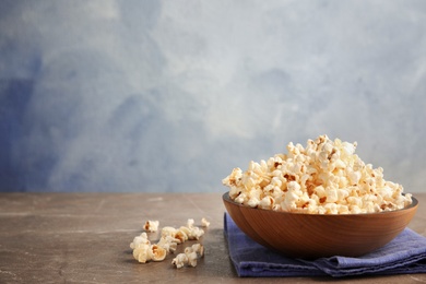 Photo of Bowl of tasty fresh popcorn on table