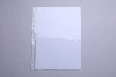 Photo of Punched pocket with paper sheet on light grey background, top view