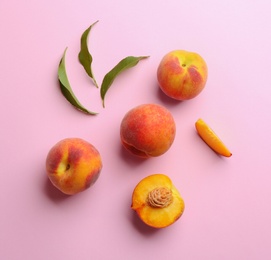 Photo of Flat lay composition with fresh peaches on pink background