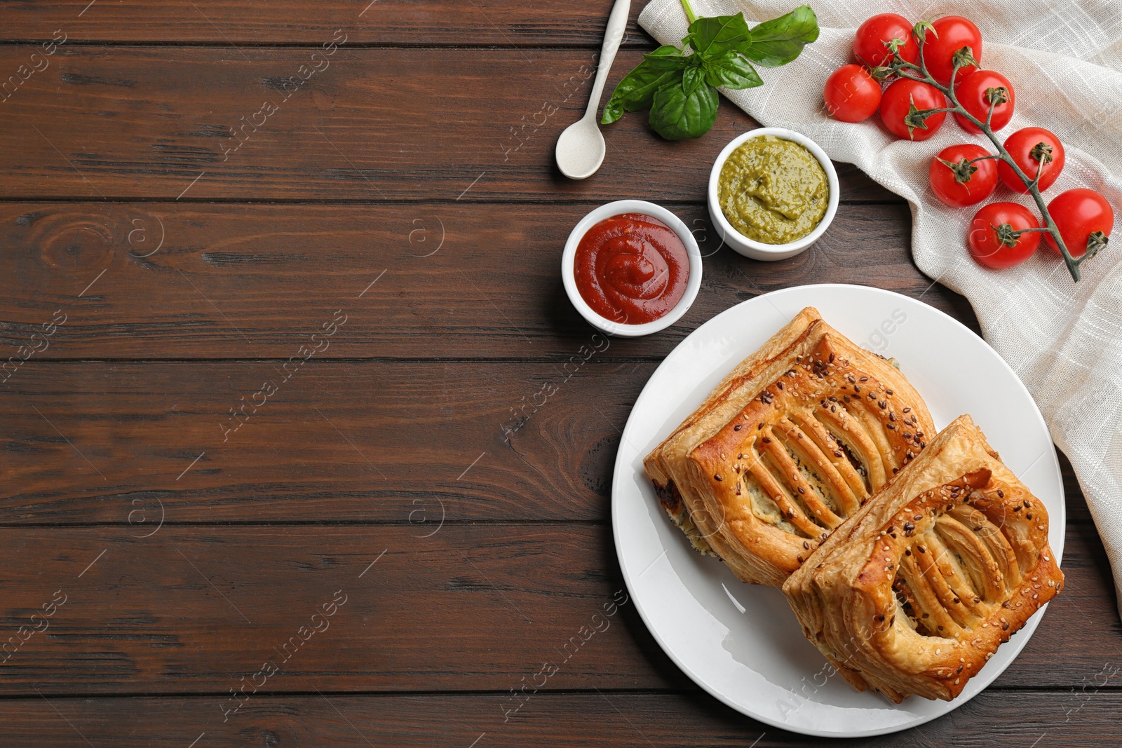 Photo of Flat lay composition with fresh delicious puff pastry on wooden table. Space for text