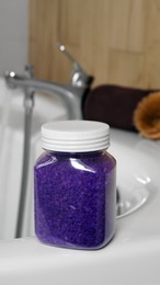 Photo of Jar with purple sea salt on bath