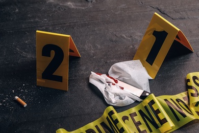 Photo of Crime scene markers and evidences on black background