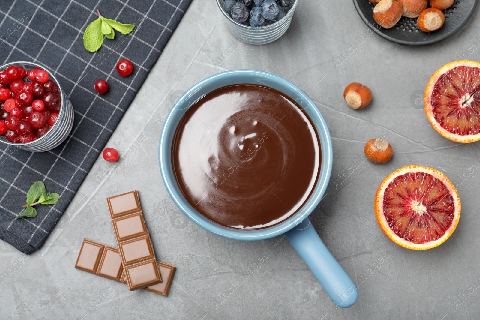 Photo of Flat lay composition with chocolate fondue on grey stone background