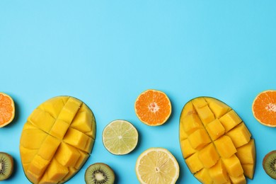 Photo of Different ripe fruits on light blue background, flat lay. Space for text