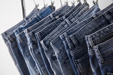 Photo of Closeup view of rack with different jeans