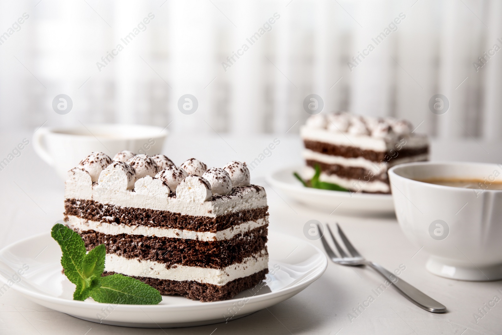 Photo of Delicious tiramisu cake on table, space for text