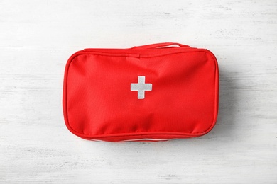 Photo of First aid kit on wooden background, top view. Health care