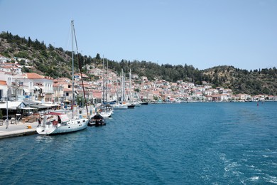 Photo of Beautiful view of coastal city with boats on sunny day