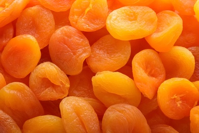 Tasty apricots as background, top view. Dried fruit as healthy food