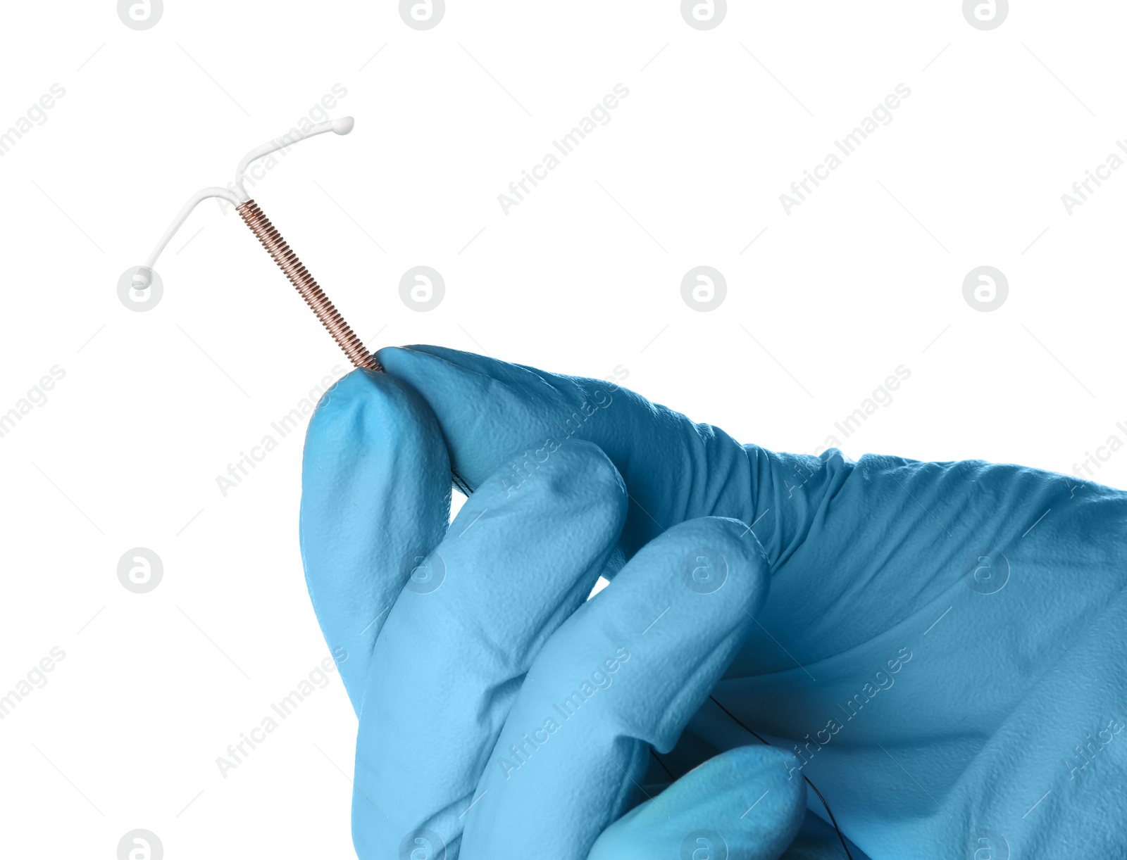 Photo of Gynecologist holding copper intrauterine contraceptive device on white background, closeup