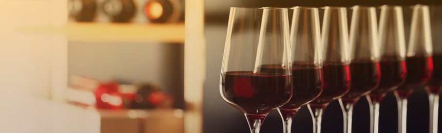 Glasses with tasty red wine, closeup view. Banner design