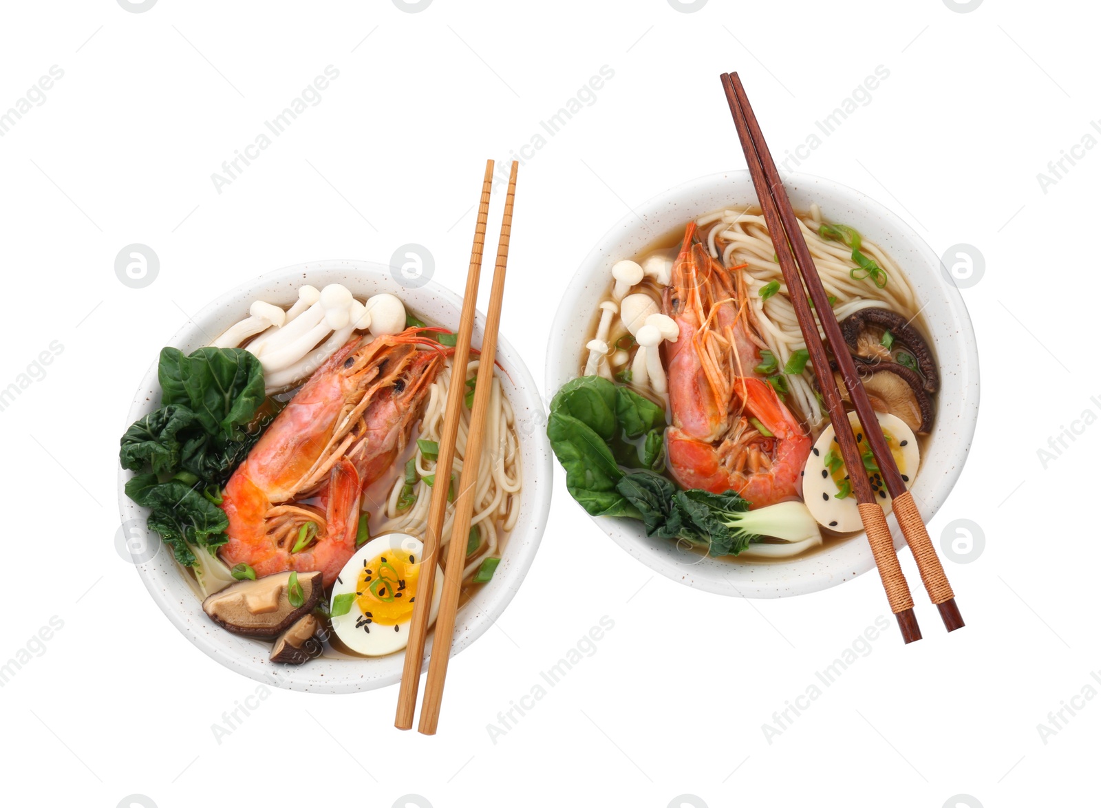 Photo of Delicious ramen with shrimps, eggs and chopsticks isolated on white, top view. Noodle soup
