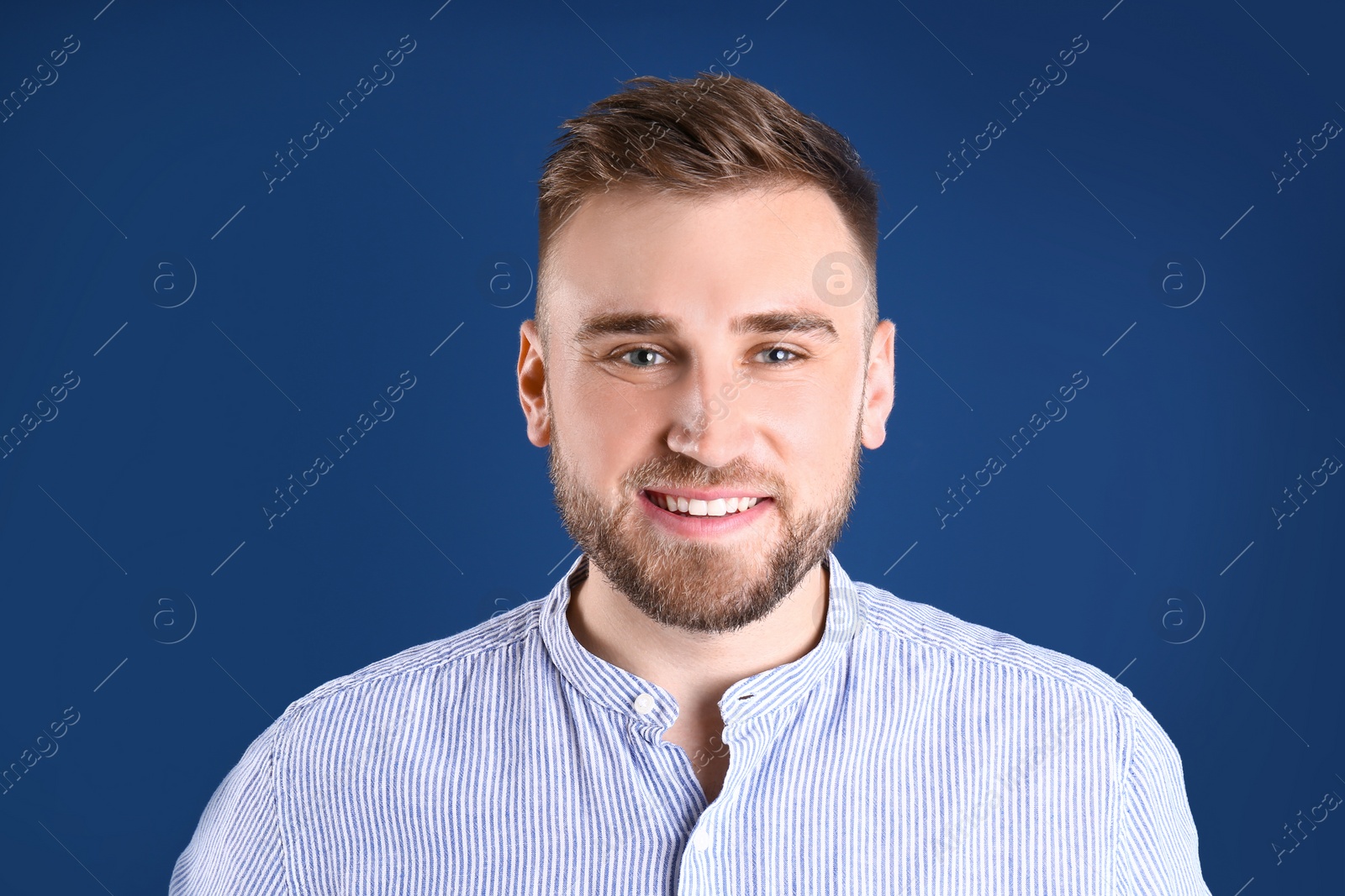 Photo of Portrait of handsome happy man on color background