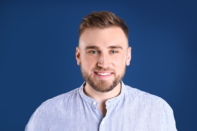 Photo of Portrait of handsome happy man on color background