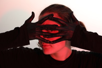 Photo of Woman with hands painted in black color on white background
