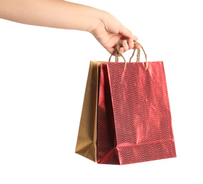 Photo of Woman holding paper shopping bags on white background, closeup. Space for design