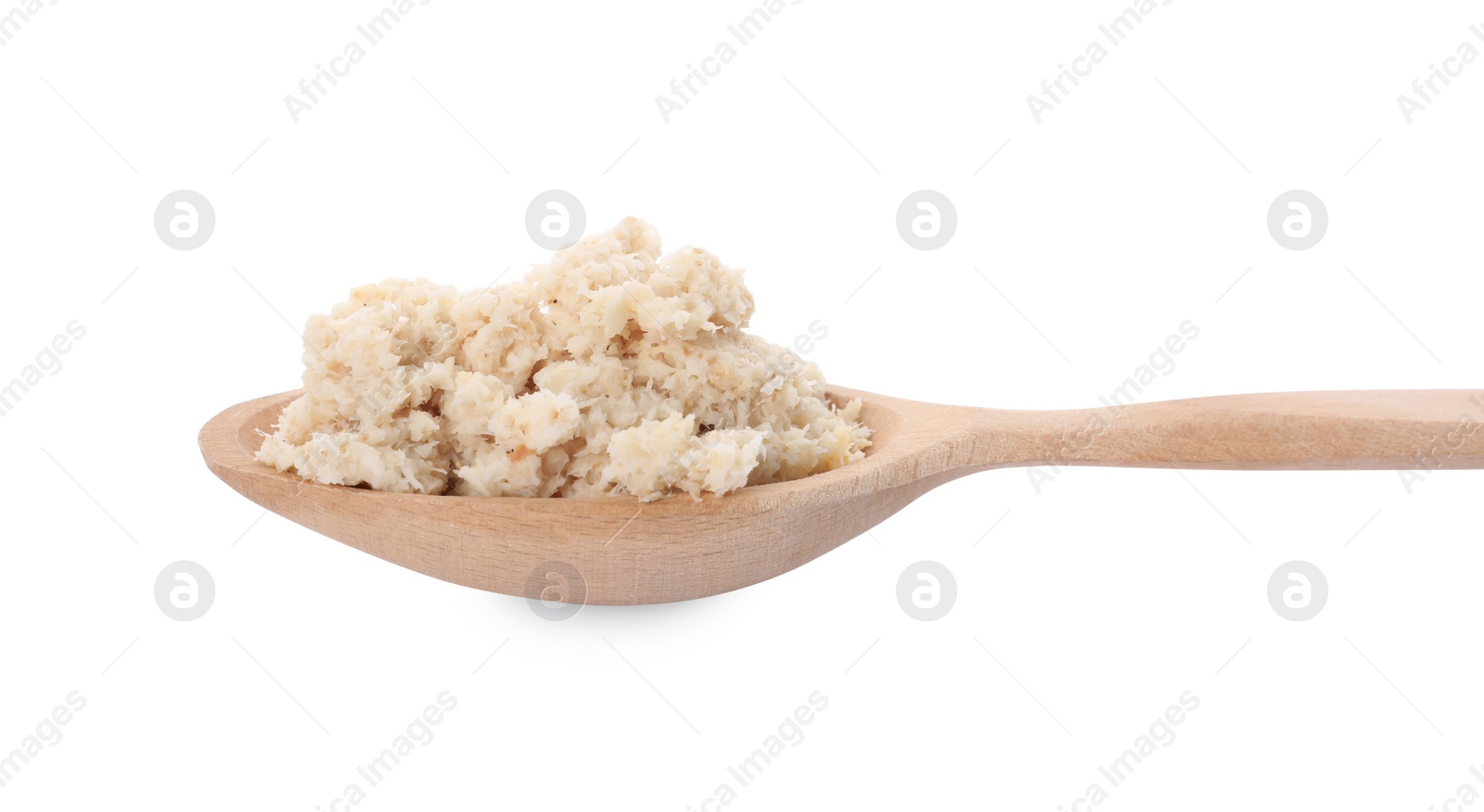 Photo of Wooden spoon with tasty prepared horseradish isolated on white