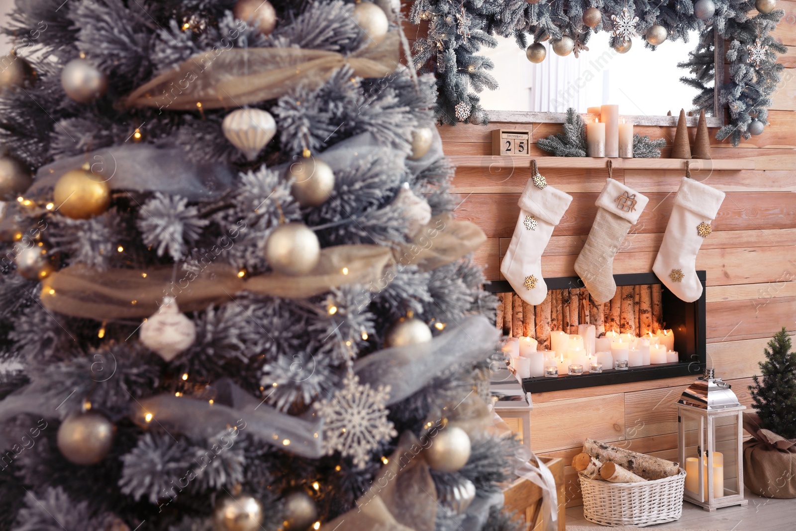 Photo of Christmas tree near decorative fireplace in room, closeup view. Festive interior