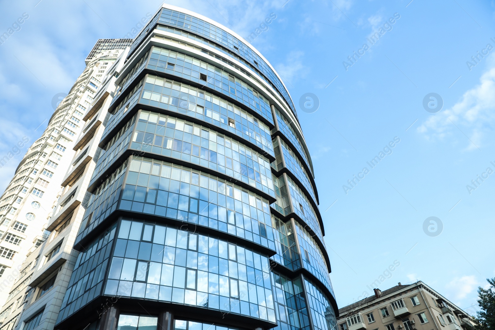 Photo of KYIV, UKRAINE - MAY 23, 2019: Modern office building against blue sky