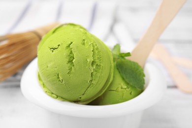 Photo of Tasty matcha ice cream in bowl on table, closeup