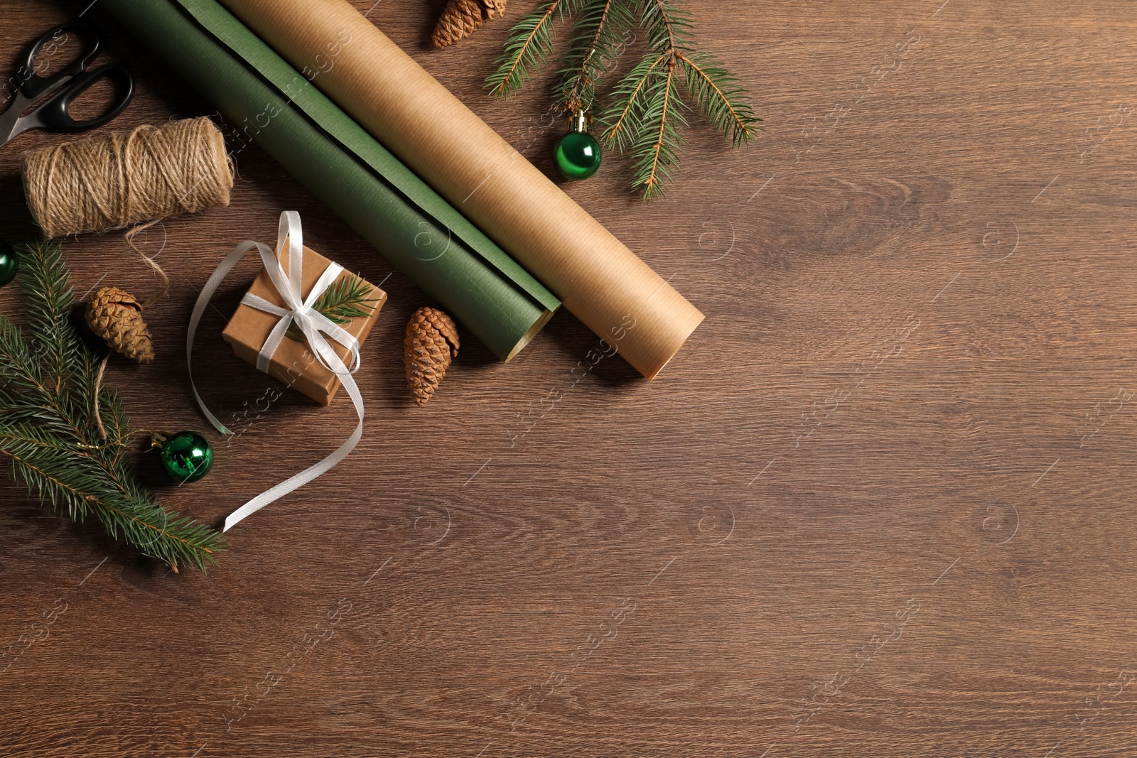 Photo of Flat lay composition with beautiful gift box and Christmas decorations on wooden table. Space for text