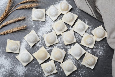 Photo of Homemade uncooked ravioli on grey table, flat lay