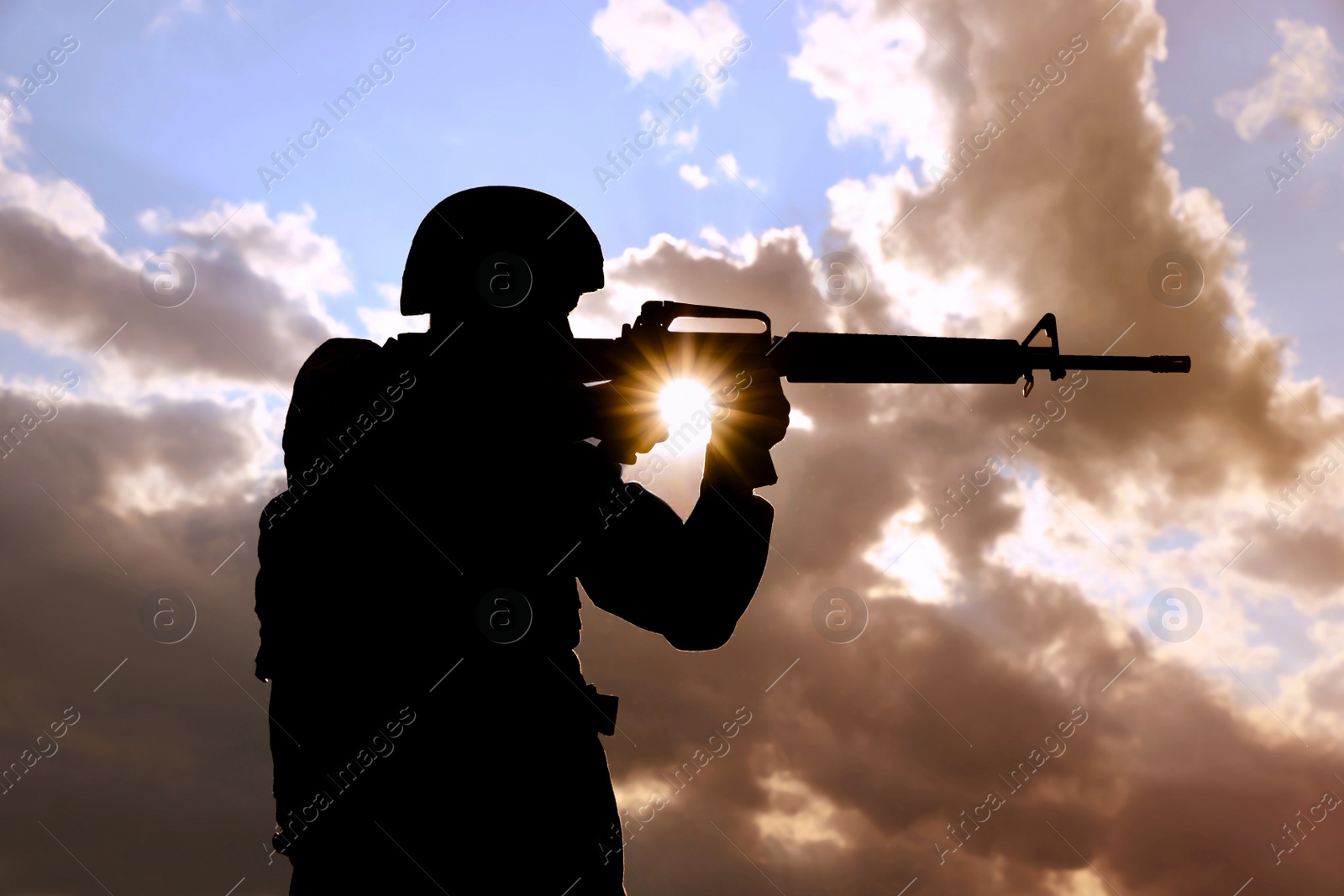 Photo of Soldier with machine gun patrolling outdoors. Military service