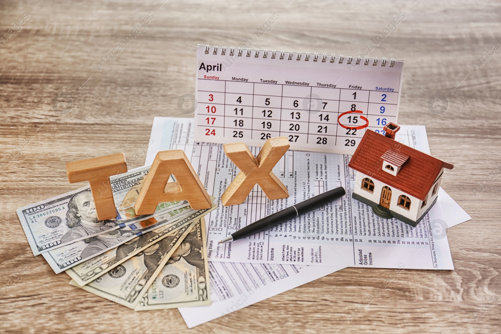 Photo of Composition with Word TAX and money on wooden table