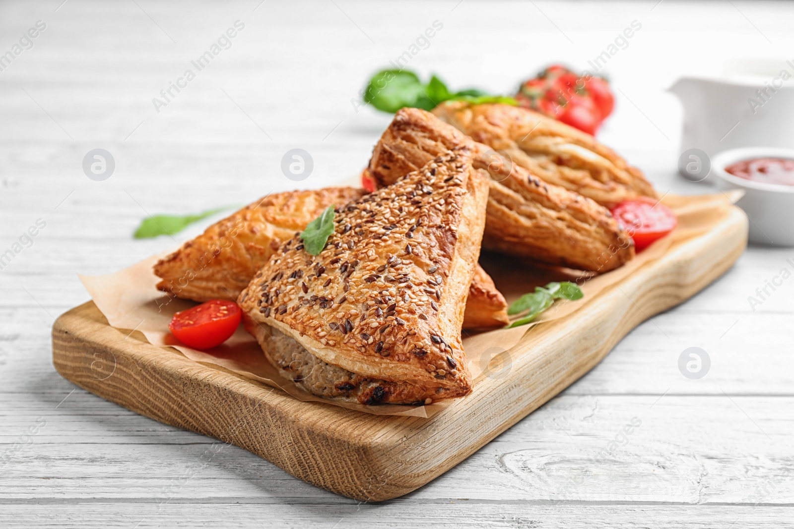 Photo of Fresh delicious puff pastry served on white wooden table