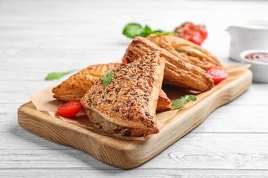 Fresh delicious puff pastry served on white wooden table