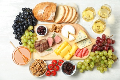 Photo of Flat lay composition with wine and snacks on white background