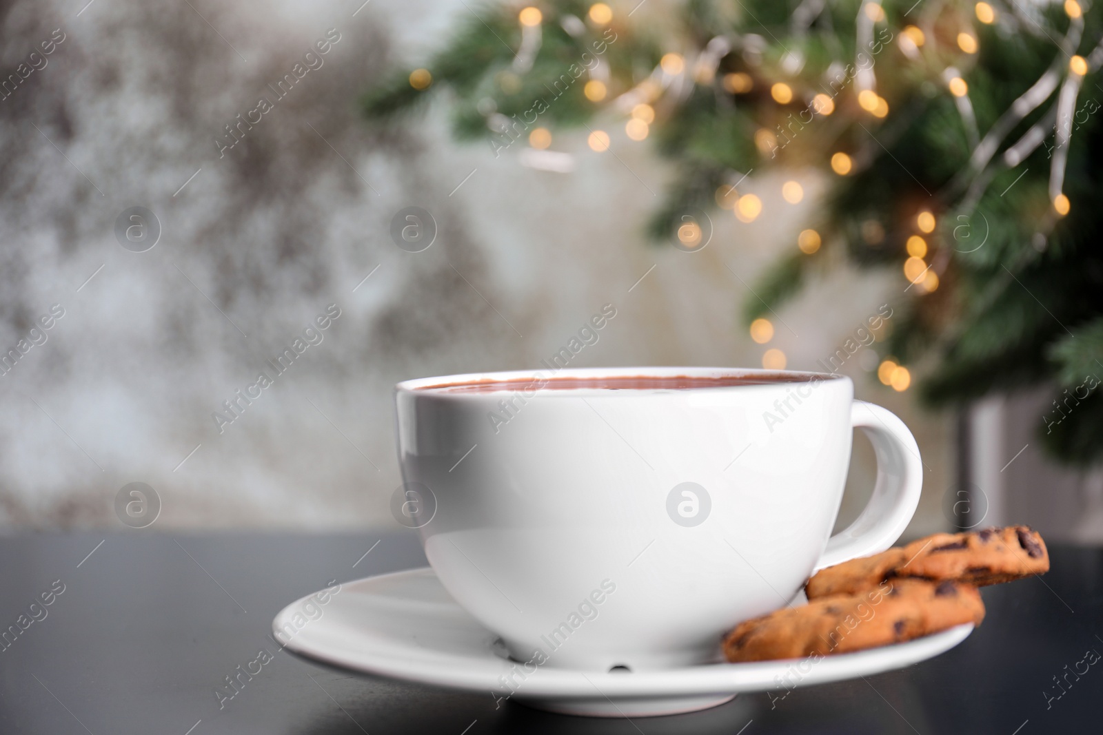 Photo of Cup of aromatic cacao with cookies on table, closeup. Space for text