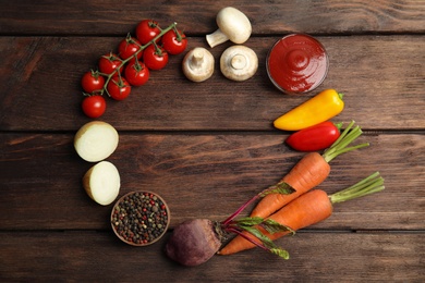 Photo of Frame of ingredients for cooking on wooden table, flat lay. Space for text