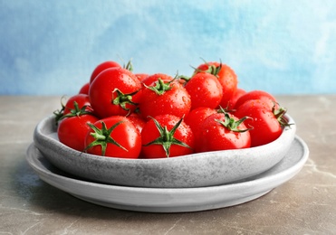 Photo of Plates with fresh ripe tomatoes on table