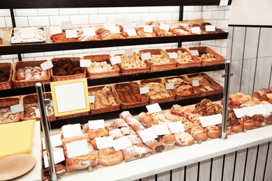 Showcase with different pastries in bakery shop