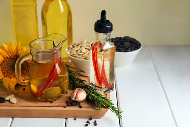 Different cooking oils and ingredients on white wooden table