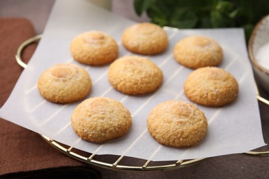 Photo of Tasty sweet sugar cookies on brown table, closeup