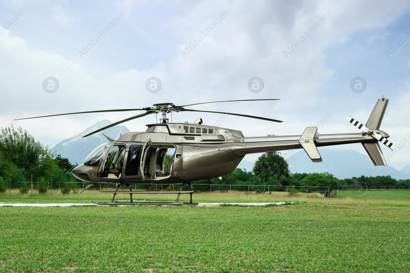 Photo of Beautiful modern helicopter on helipad in field