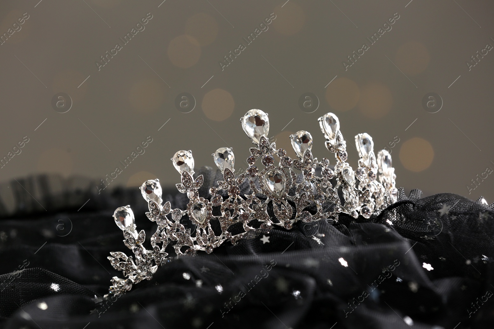 Photo of Beautiful silver tiara with diamonds on dark cloth